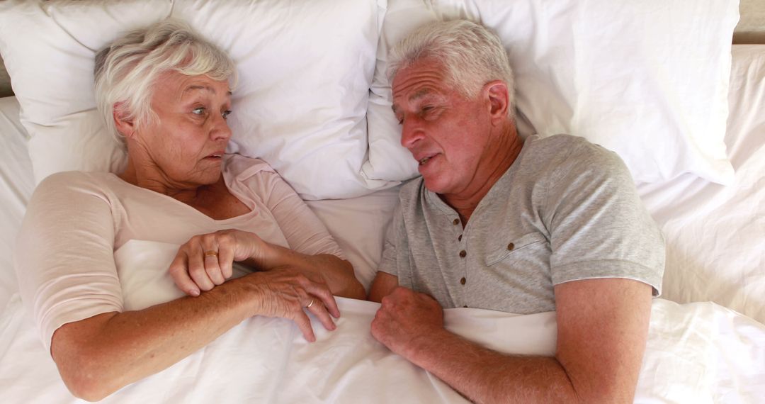 Senior Couple Relaxing and Connecting in Comfortable Bed