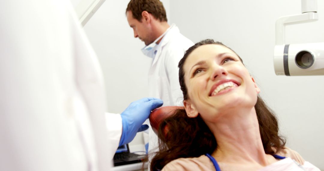 Dental Patient Smiling During Routine Examination with Dentist - Free Images, Stock Photos and Pictures on Pikwizard.com