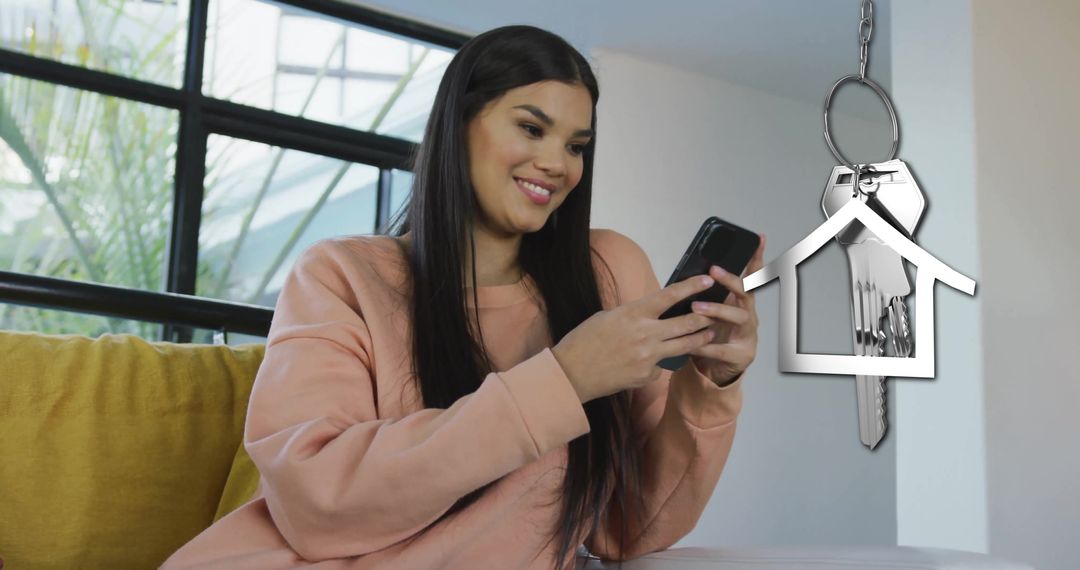Happy Woman on Smartphone with House Key Symbolizing Home Ownership