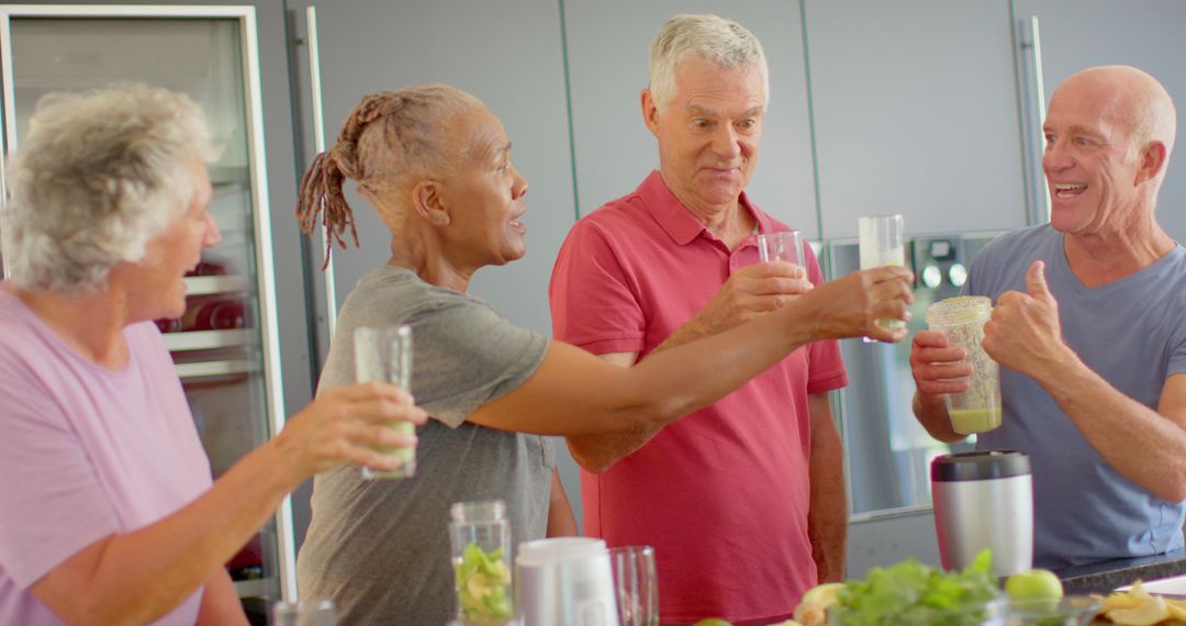 Senior Friends Toasting with Healthy Smoothies in Modern Kitchen - Free Images, Stock Photos and Pictures on Pikwizard.com