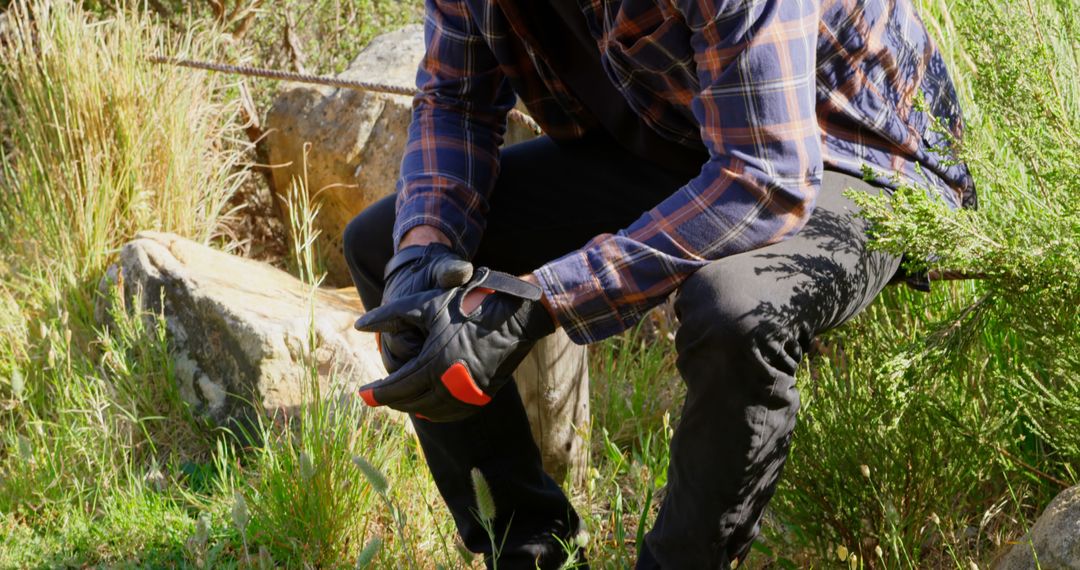 Man Wearing Black Gloves Pruning Plants Outdoors - Free Images, Stock Photos and Pictures on Pikwizard.com