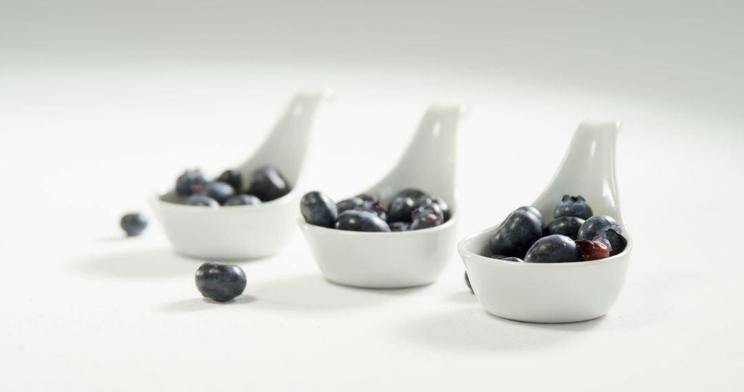 Fresh Blueberries in White Ceramic Spoons Simple Presentation - Free Images, Stock Photos and Pictures on Pikwizard.com