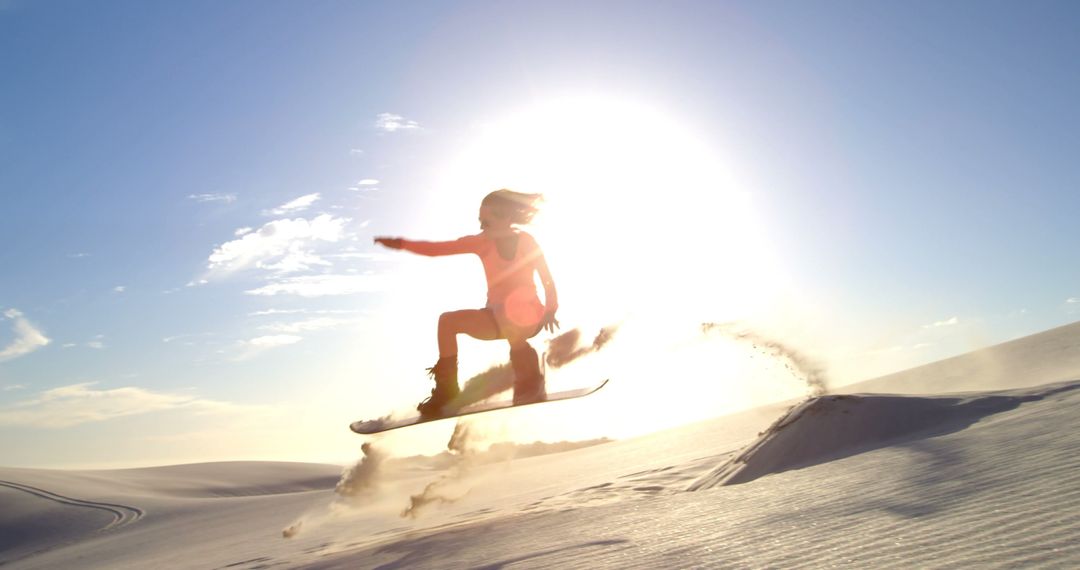 Snowboarder Jumping on Sand Dune During Sunset - Free Images, Stock Photos and Pictures on Pikwizard.com