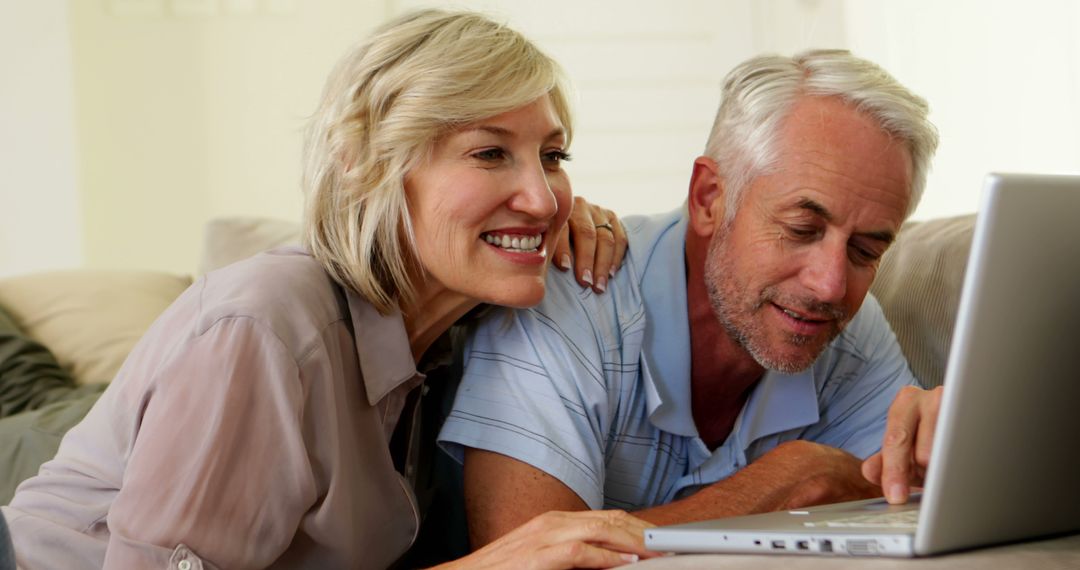 Happy Senior Couple Enjoying Laptop at Home Together