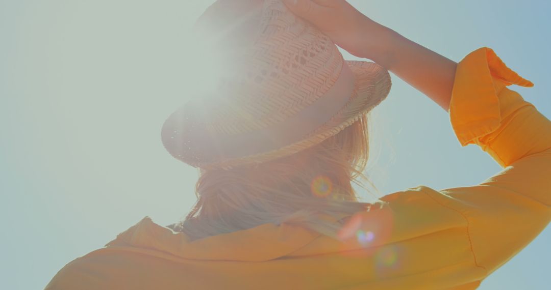 Woman in Sunlight with Wide-Brimmed Hat Enjoying Summer - Free Images, Stock Photos and Pictures on Pikwizard.com