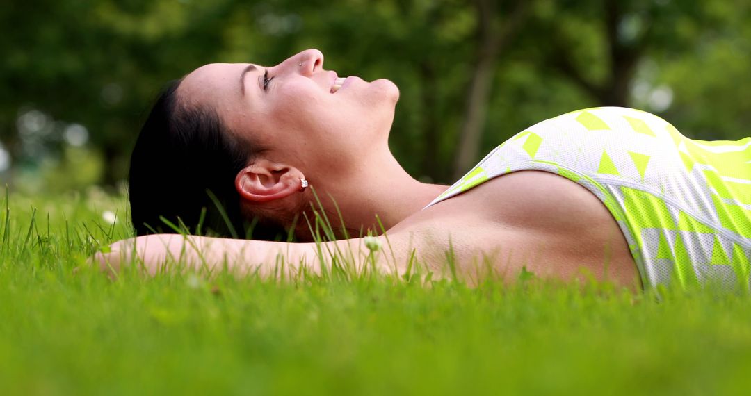 Woman Lying on Grass Relaxing in the Park on Sunny Day - Free Images, Stock Photos and Pictures on Pikwizard.com