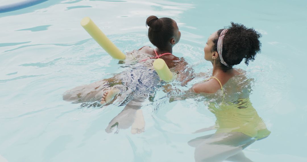 Mother Teaching Daughter to Swim in Pool - Free Images, Stock Photos and Pictures on Pikwizard.com