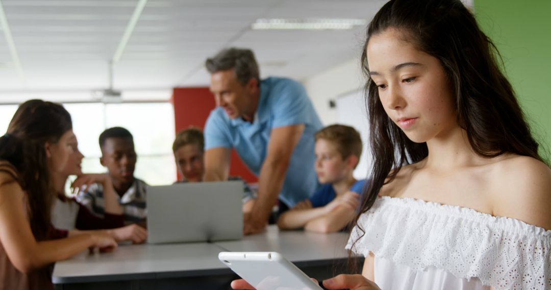 Teenage Girl Using Tablet in Classroom Setting - Free Images, Stock Photos and Pictures on Pikwizard.com