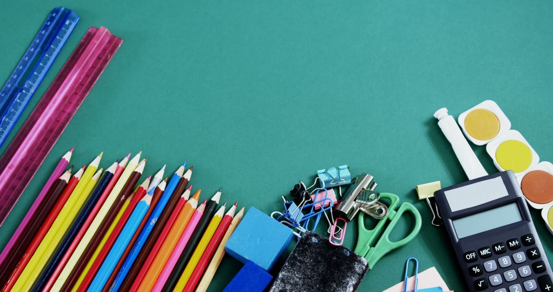 Colorful School and Office Supplies Arranged on Green Background - Free Images, Stock Photos and Pictures on Pikwizard.com