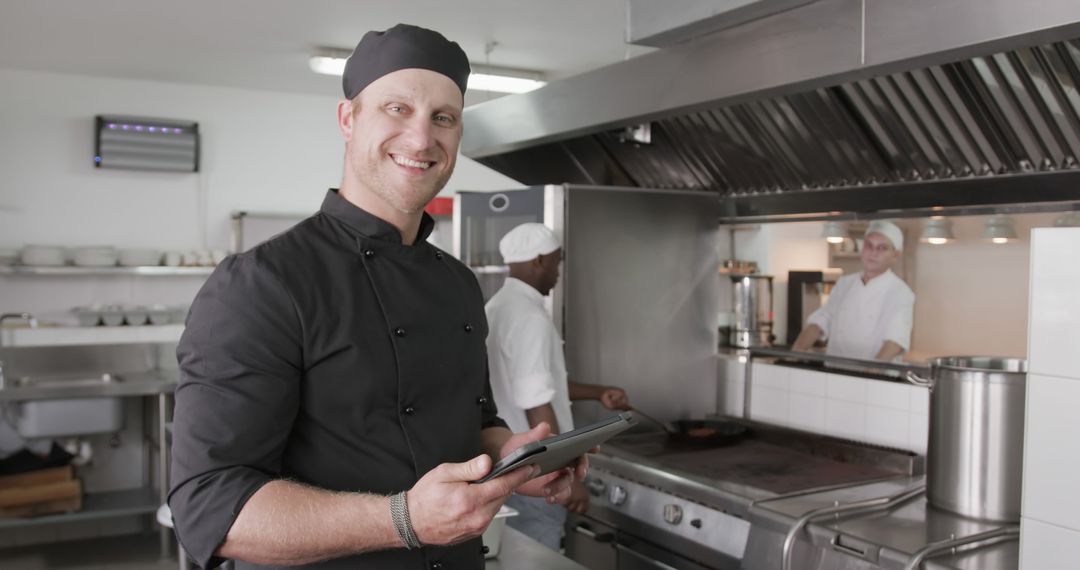 Chef Using Tablet in Professional Kitchen Setting - Free Images, Stock Photos and Pictures on Pikwizard.com