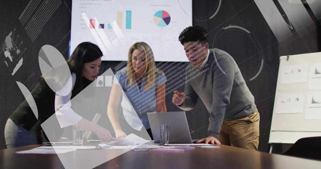 Team Collaborating Over Laptop and Charts While Analyzing Business Data in Modern Boardroom