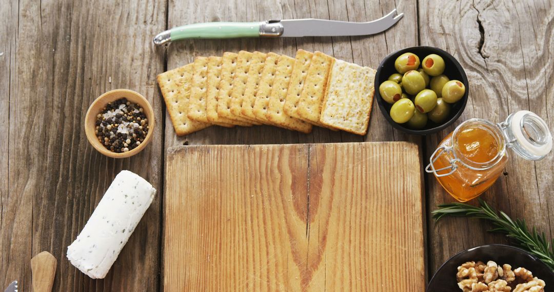 Rustic Cheese Platter with Crackers, Olives, and Nuts on Wooden Table - Free Images, Stock Photos and Pictures on Pikwizard.com