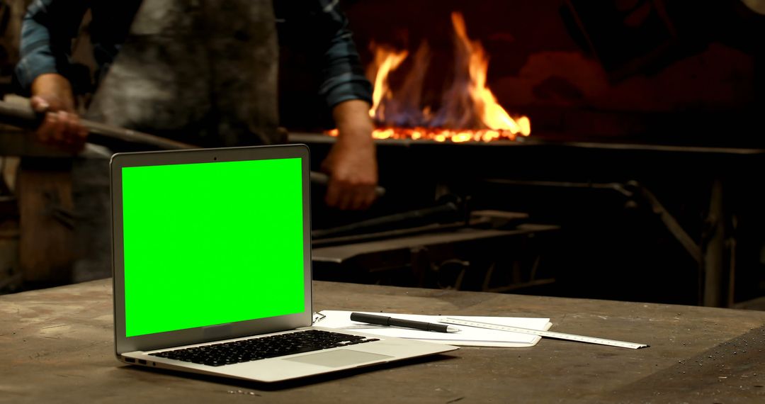 Laptop with Green Screen on Blacksmith Workbench - Free Images, Stock Photos and Pictures on Pikwizard.com