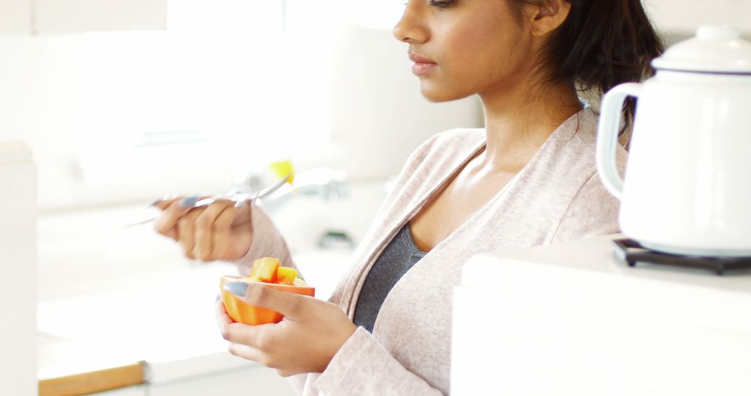 Woman Enjoying Healthy Breakfast in Bright Kitchen - Free Images, Stock Photos and Pictures on Pikwizard.com