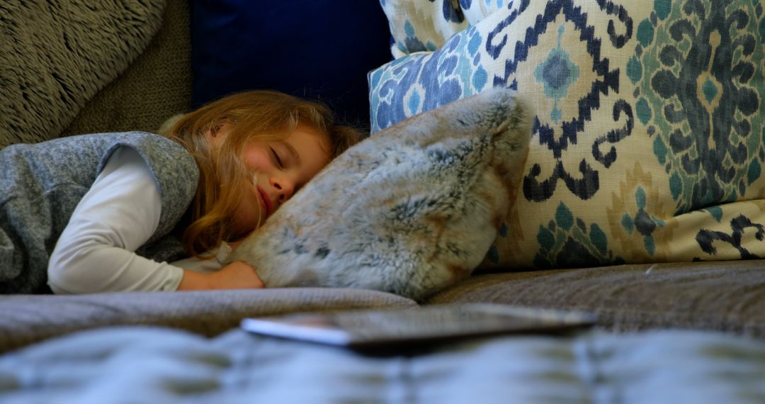 Little Girl Sleeping Peacefully on a Cozy Couch with Pillows - Free Images, Stock Photos and Pictures on Pikwizard.com