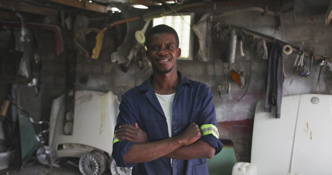 Confident African Male Panel Beater in Workshop Smiling