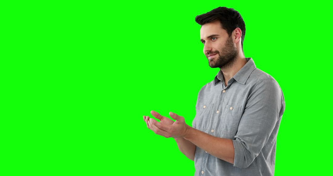 Man Smiling and Clapping Hands Against Green Screen Background - Free Images, Stock Photos and Pictures on Pikwizard.com