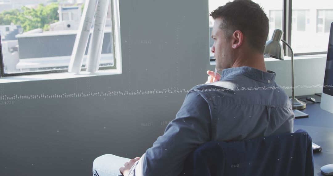 Thoughtful Businessman Analyzing Data in Office Environment