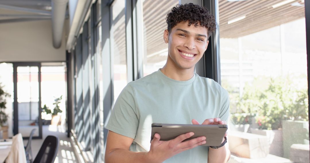 Young Professional Using Tablet in Bright Modern Office Environment