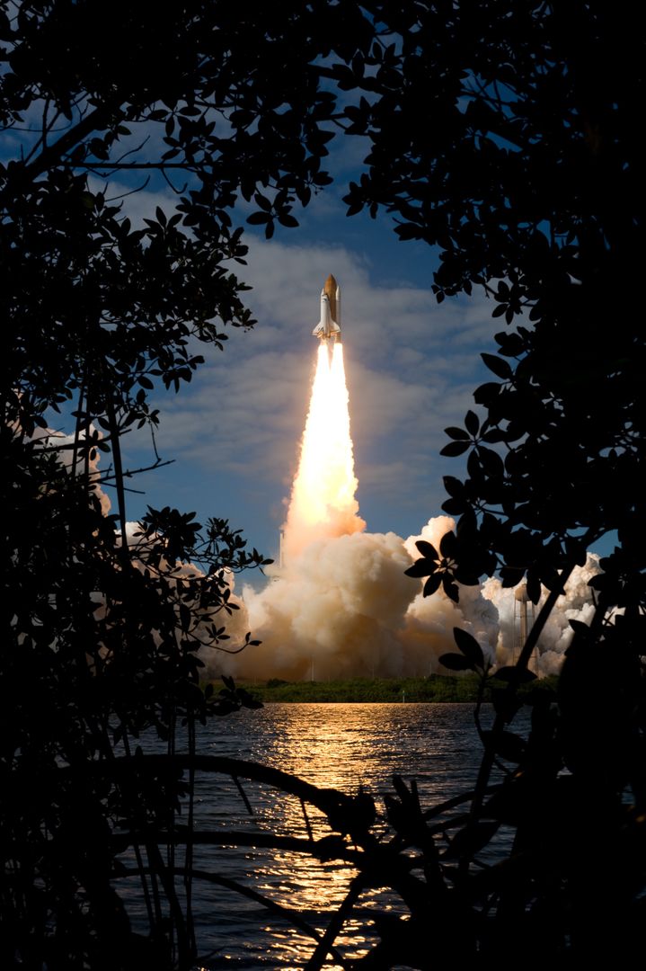 Space Shuttle Atlantis Lifts Off through Tropical Vegetation at Cape Canaveral - Free Images, Stock Photos and Pictures on Pikwizard.com