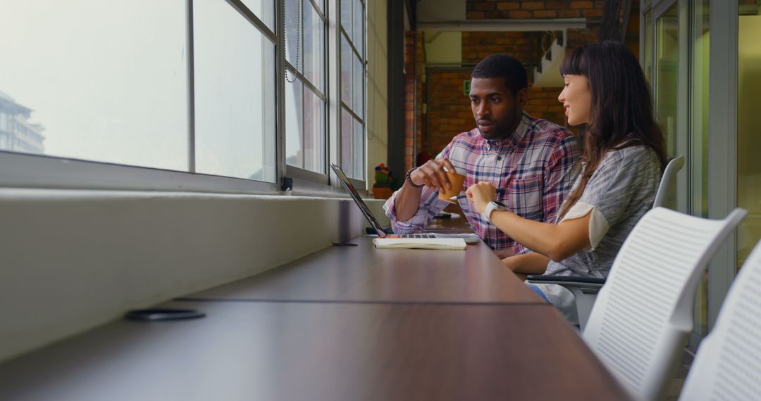 Colleagues Collaborating on Work in Modern Office Environment