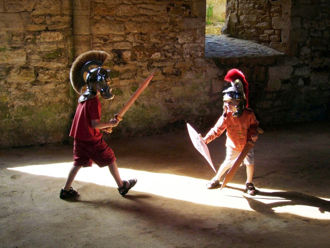 Young Boys Playing Knight Battle in Ancient Ruins - Free Images, Stock Photos and Pictures on Pikwizard.com