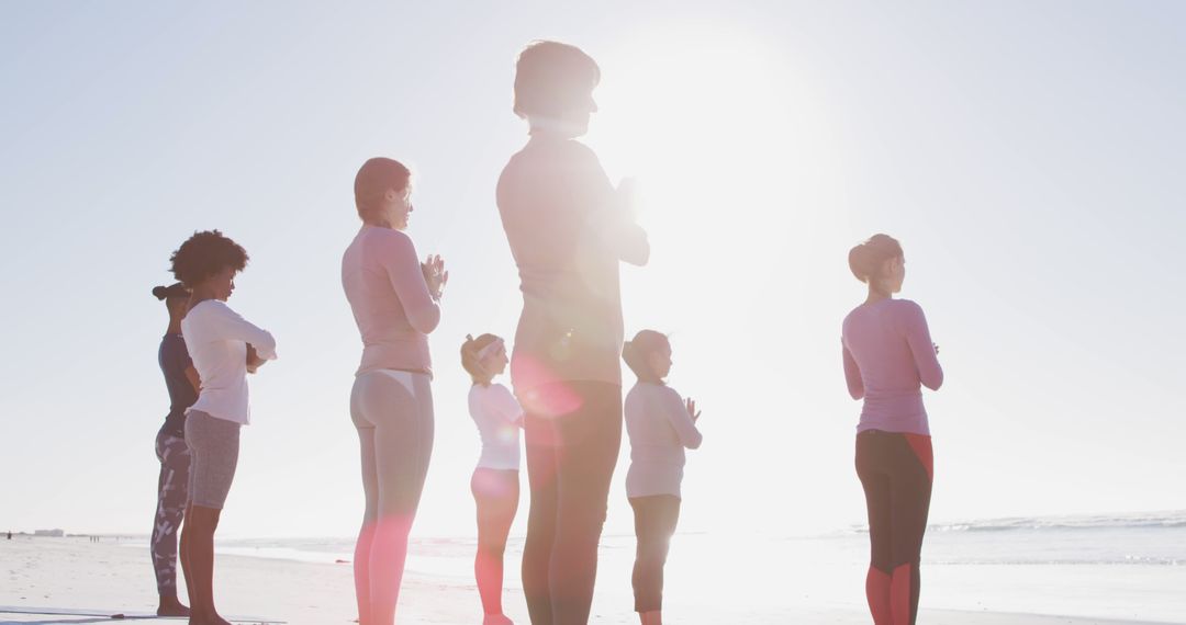 Group Practicing Yoga At Beach During Sunrise - Free Images, Stock Photos and Pictures on Pikwizard.com