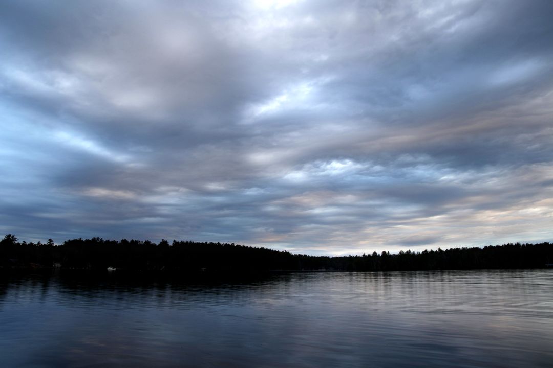 Serene Lake under Dramatic Cloudy Sky at Dusk - Free Images, Stock Photos and Pictures on Pikwizard.com