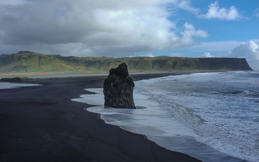 Dramatic Black Sand Beach with Sea Stack in Iceland - Free Images, Stock Photos and Pictures on Pikwizard.com