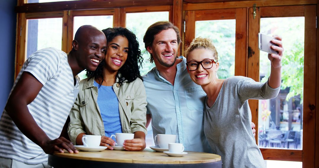 Diverse Group of Friends Smiling and Taking Selfie in Cozy Cafe - Free Images, Stock Photos and Pictures on Pikwizard.com