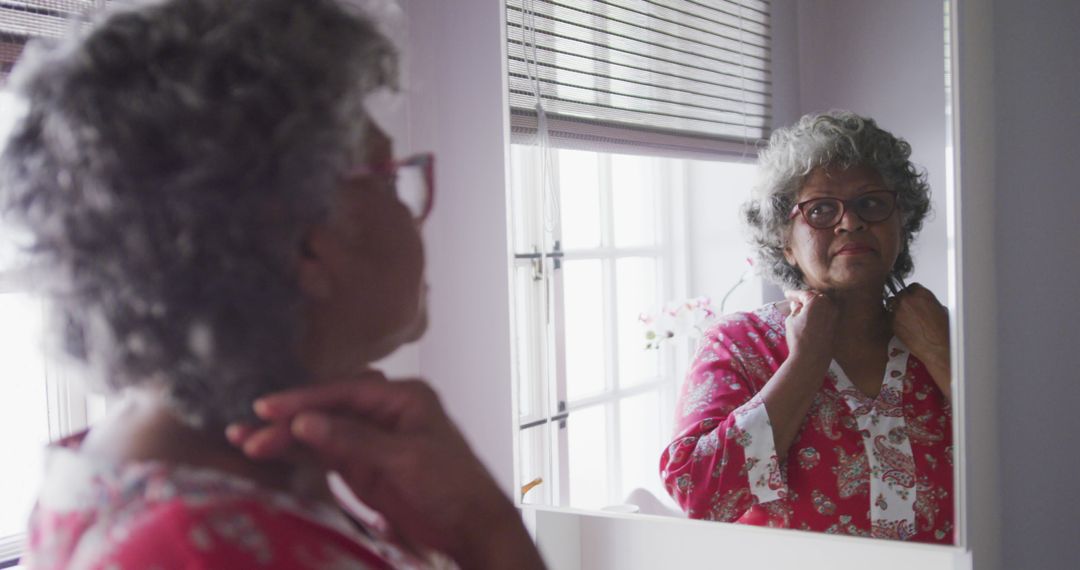 Elderly woman admiring herself in mirror - Free Images, Stock Photos and Pictures on Pikwizard.com