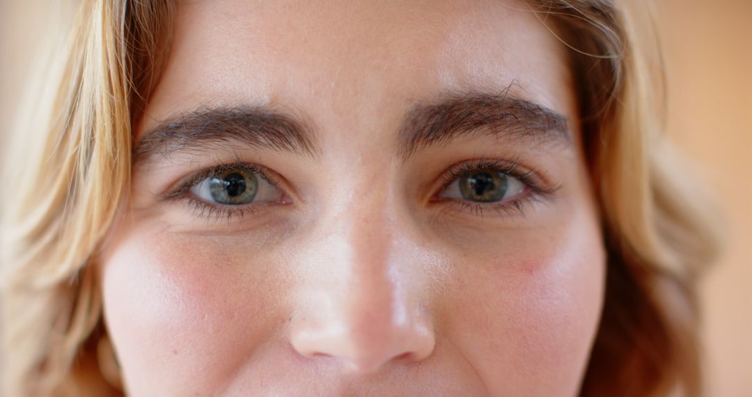 Close-Up on Woman's Face Highlighting Smooth Skin and Expressive Eyes