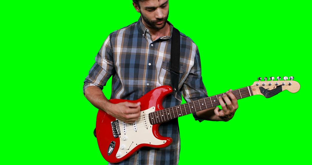 Male musician playing guitar against green screen - Free Images, Stock Photos and Pictures on Pikwizard.com