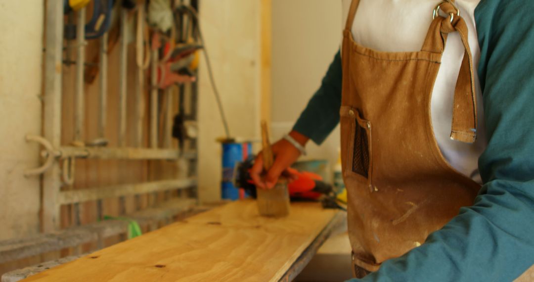 Craftsman Applying Wood Finish in Workshop - Free Images, Stock Photos and Pictures on Pikwizard.com