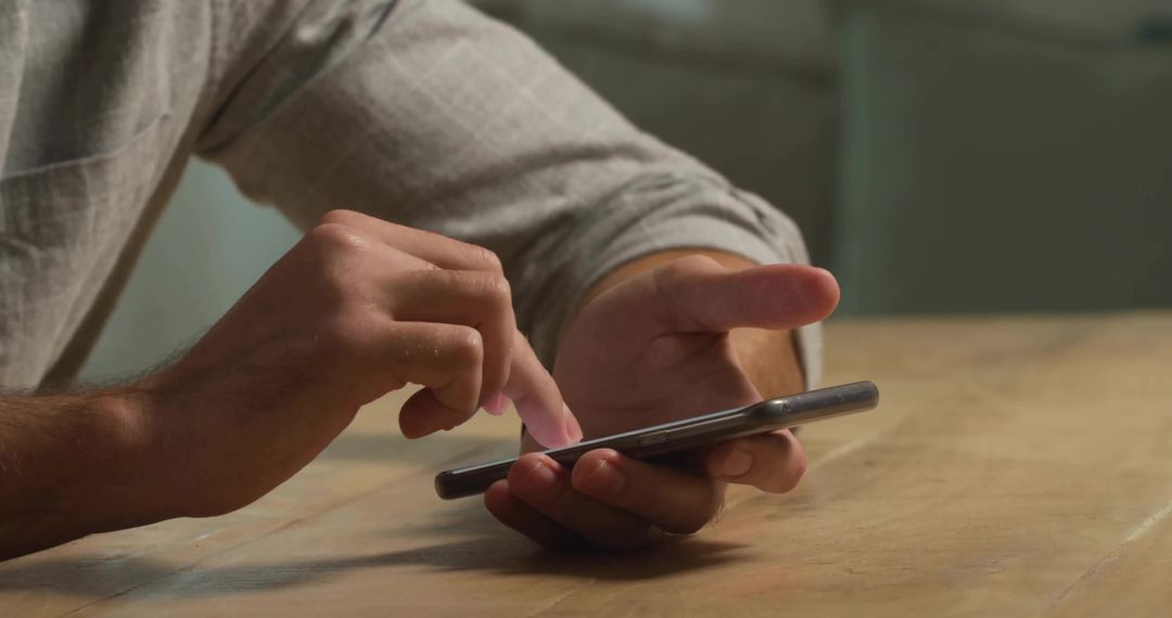 Man Using Smartphone in Home Office for Communication