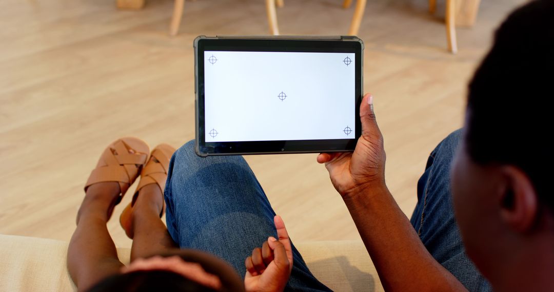 Father and Daughter Using Tablet for Relaxed Family Time