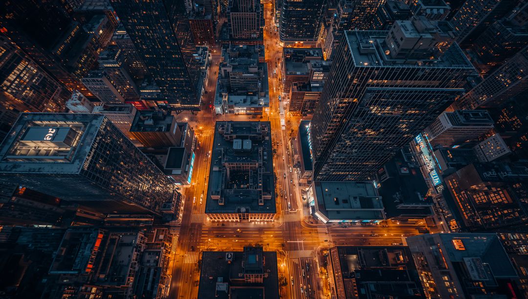 Glowing Urban Grid Showing Lit Four-Way Intersection from Birdseye Night Aerial