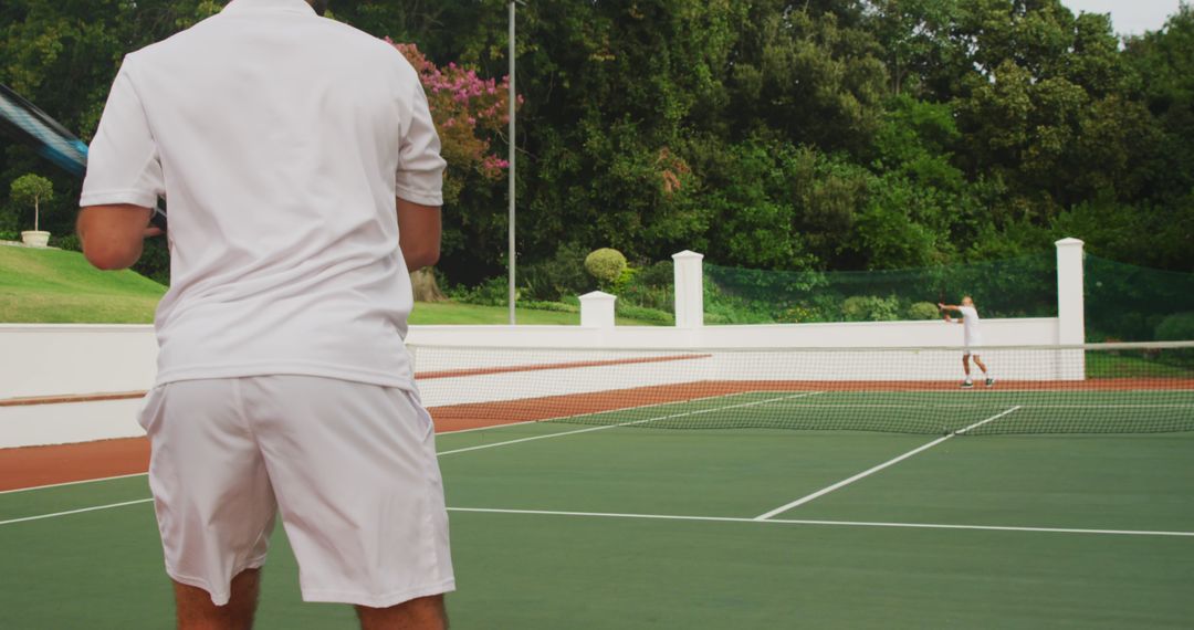 Men Playing Tennis Outdoors on Scenic Court - Free Images, Stock Photos and Pictures on Pikwizard.com