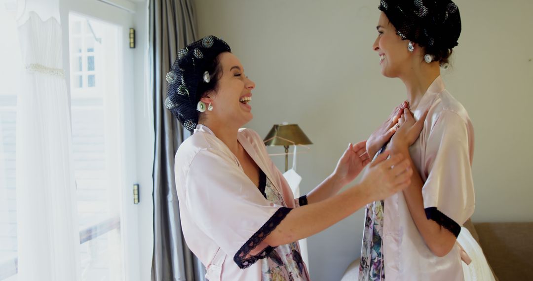 Two Happy Women Laughing and Chatting in Morning Robes - Free Images, Stock Photos and Pictures on Pikwizard.com