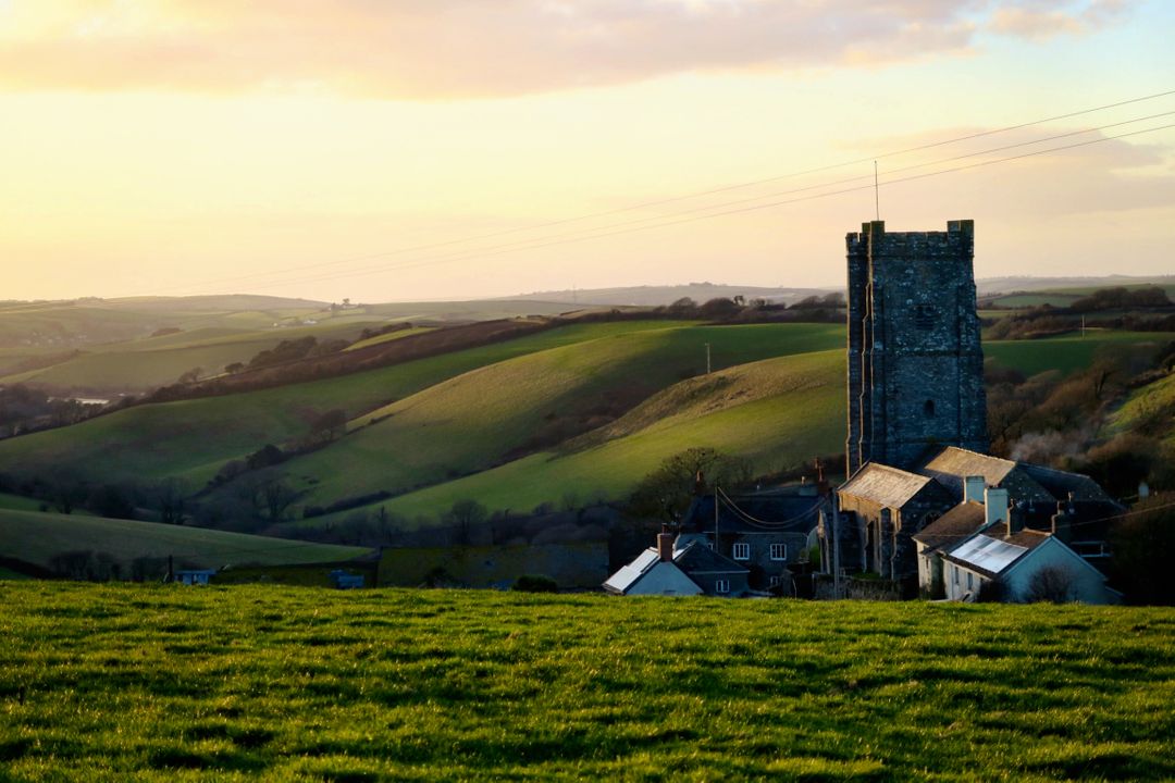 Historic Village Church and Rolling Hills in Evening Light - Free Images, Stock Photos and Pictures on Pikwizard.com