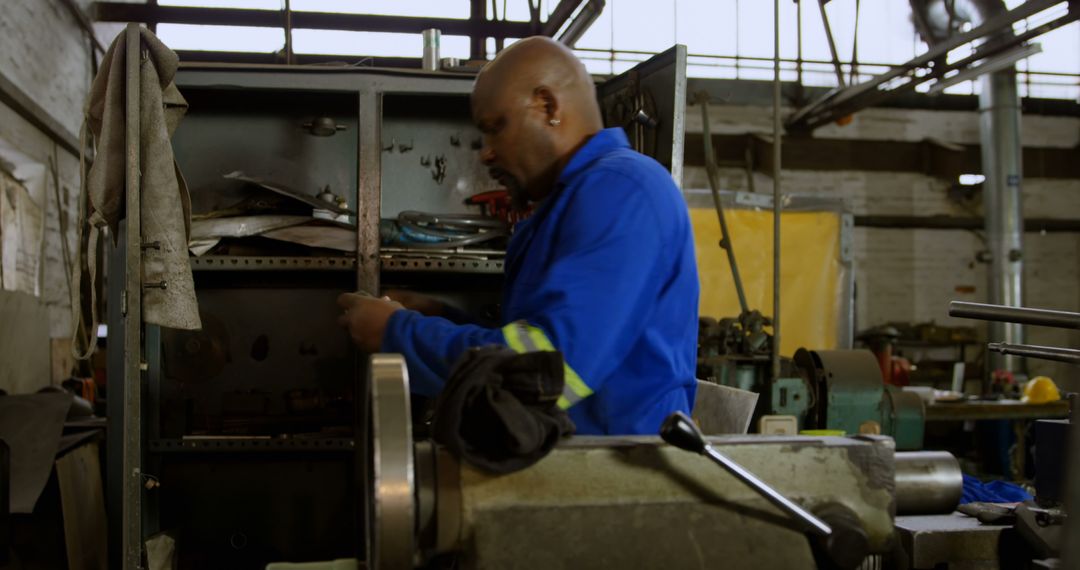 Skilled Technician Maintaining Industrial Machinery in Workshop