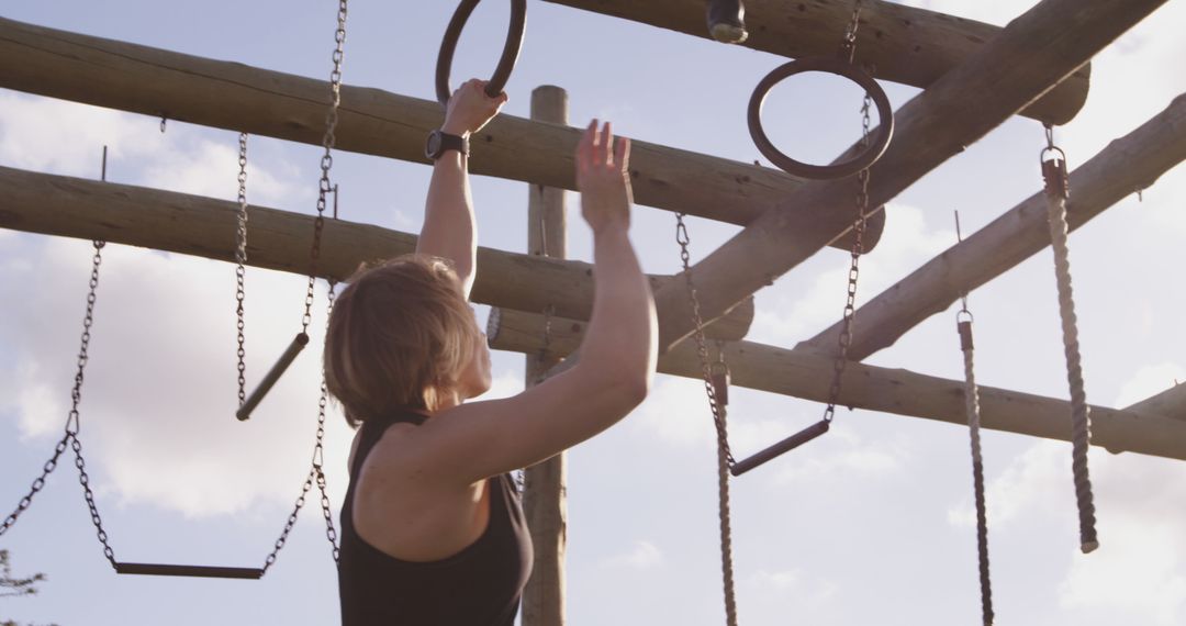 Woman Training on Outdoor Obstacle Course Rings - Free Images, Stock Photos and Pictures on Pikwizard.com