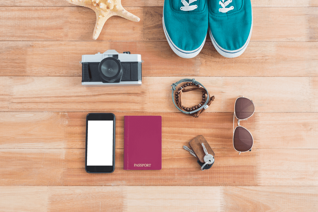 Travel Journey Essentials on Wood Background with Camera and Passport