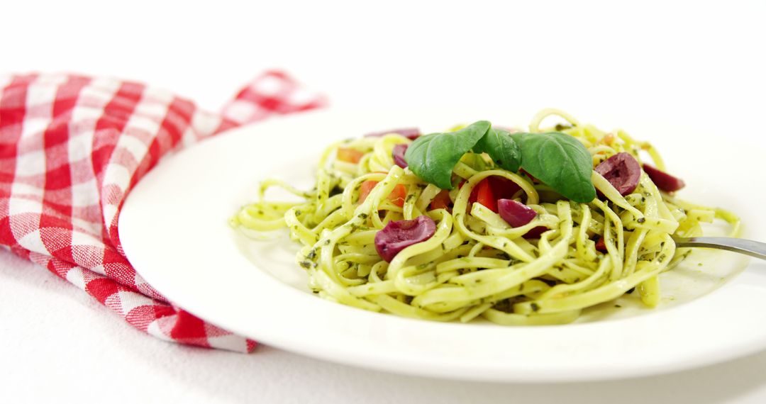 Italian Pasta Salad with Green Basil Pesto and Red Checker Cloth - Free Images, Stock Photos and Pictures on Pikwizard.com