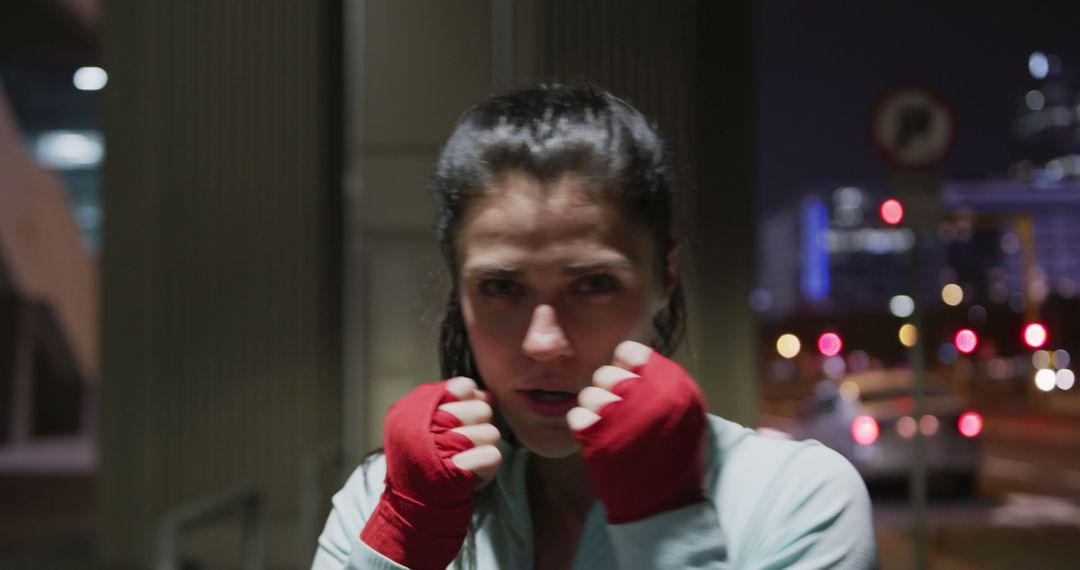 Determined Female Boxer Training Outdoors at Night - Free Images, Stock Photos and Pictures on Pikwizard.com