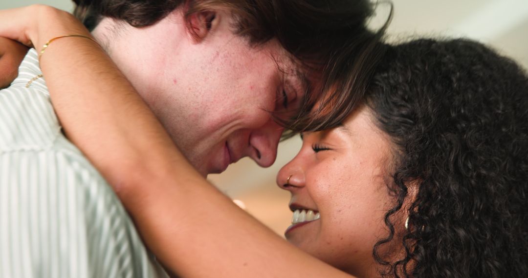 Happy Multiracial Couple Embracing During Anniversary Celebration