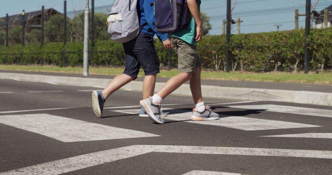 Two Young Boys Crossing Street on Pedestrian Crosswalk - Free Images, Stock Photos and Pictures on Pikwizard.com