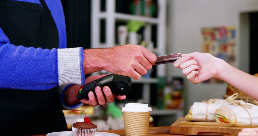 Close-up of Cashier and Customer Completing Contactless Payment in Cafe - Free Images, Stock Photos and Pictures on Pikwizard.com