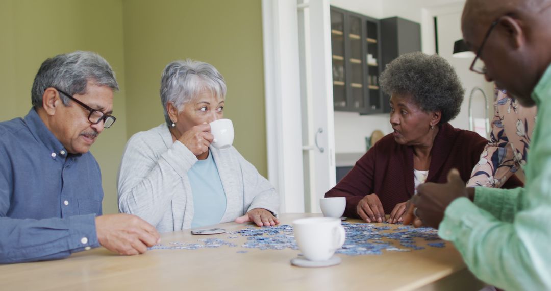 Diverse Group of Senior Adults Enjoying a Puzzle and Coffee Together - Free Images, Stock Photos and Pictures on Pikwizard.com