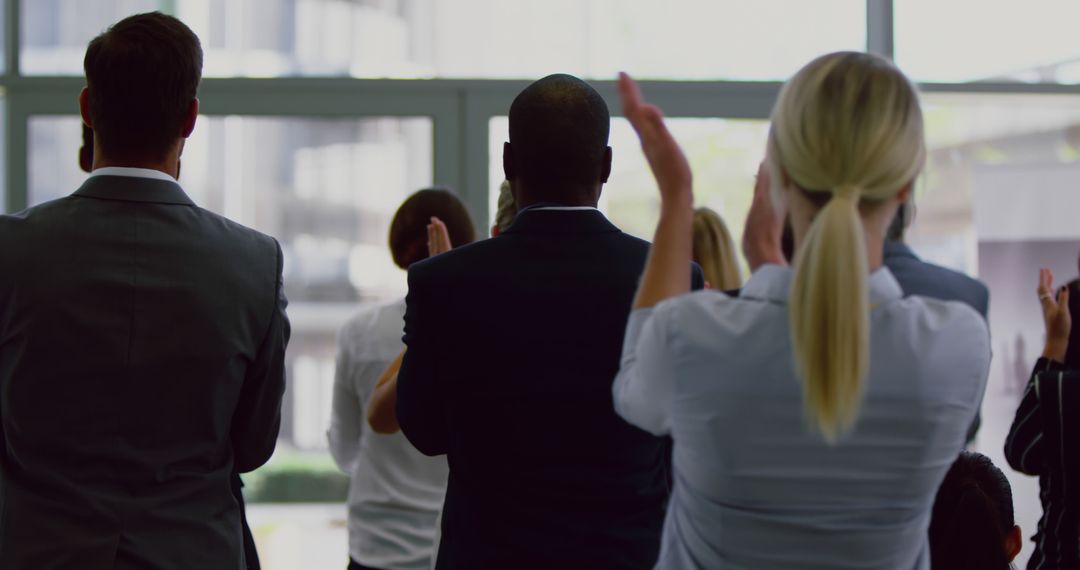Business Audience Clapping at Seminar Presentation